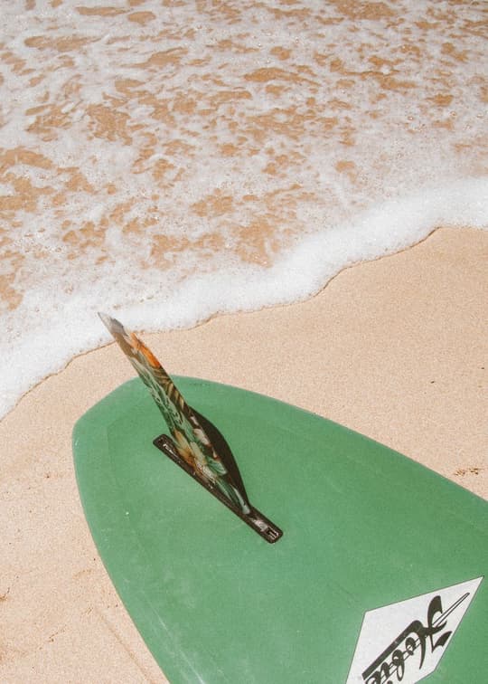 Surfboard on Sandy Shore